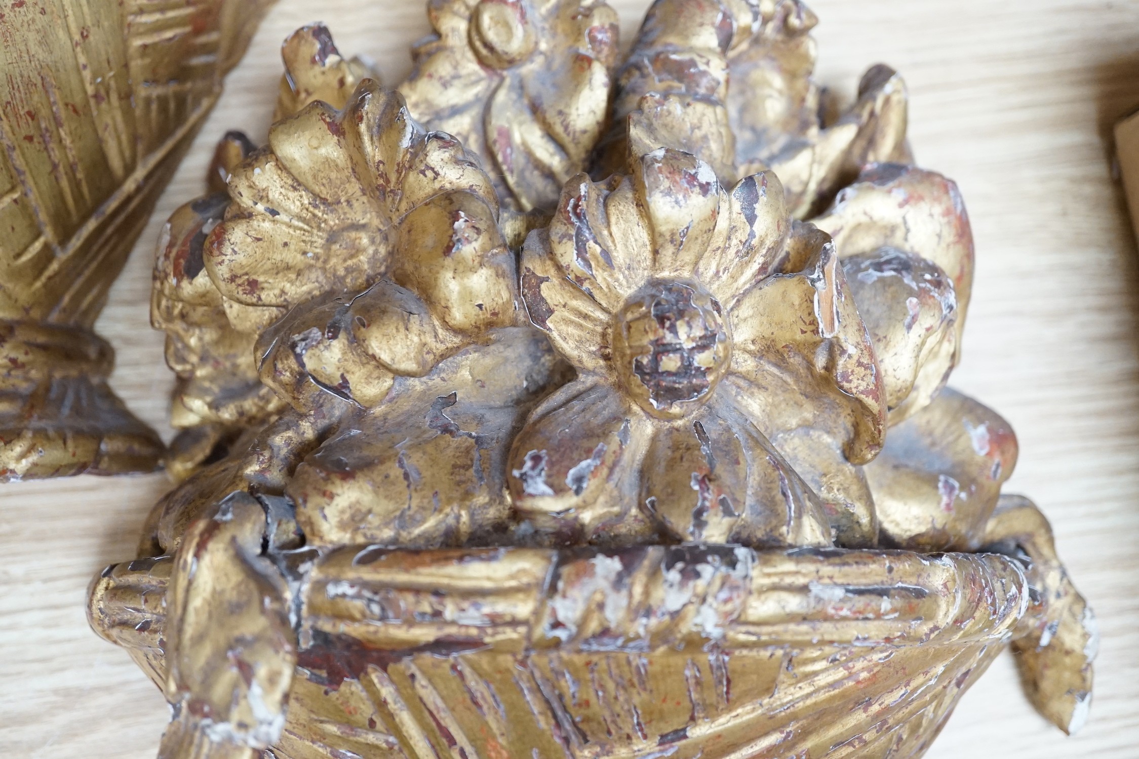 A pair of carved giltwood basket wall sconces, 29cms high